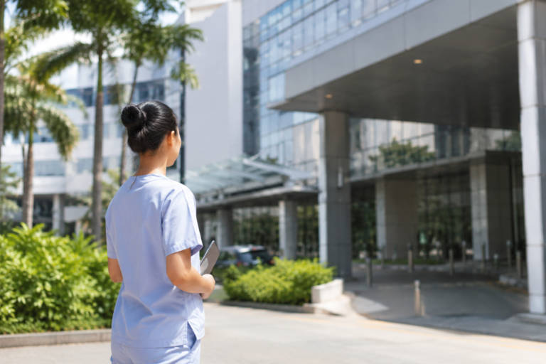 Internationally educated nurse outside a Singapore hospital representing nursing jobs in Singapore 2026