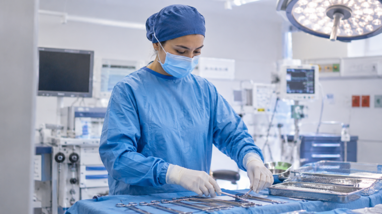 OR nurse preparing a surgical instrument tray in an operating room, representing the perioperative nursing career guide 2026